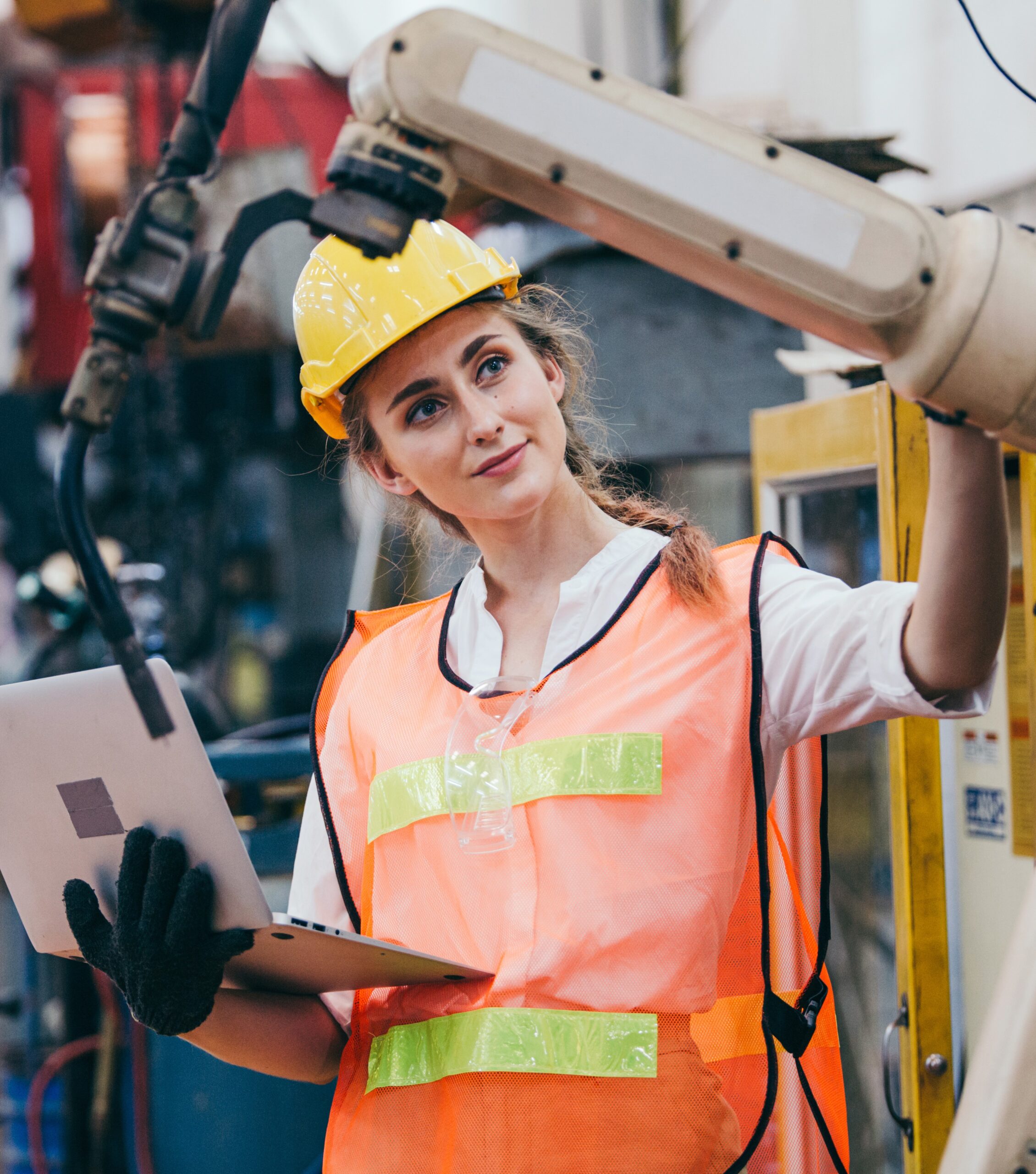 female worker working with laptop at robotic factory
